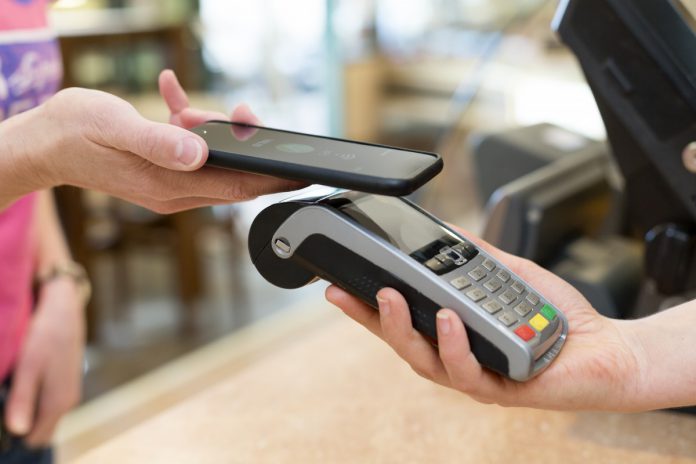 Woman using phone to pay.