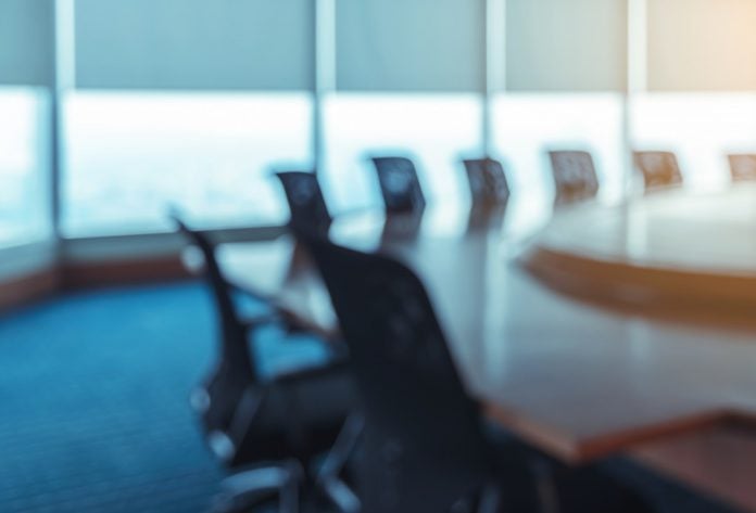 A blurred image of a boardroom.