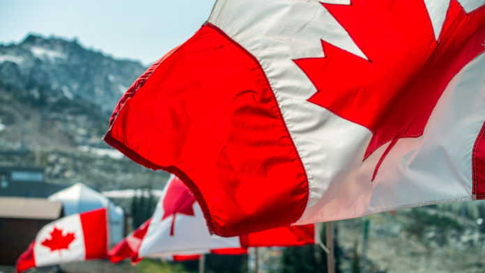 Three flags of Canada in wind.