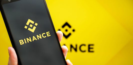 A person holding a smart phone with the Binance.US app