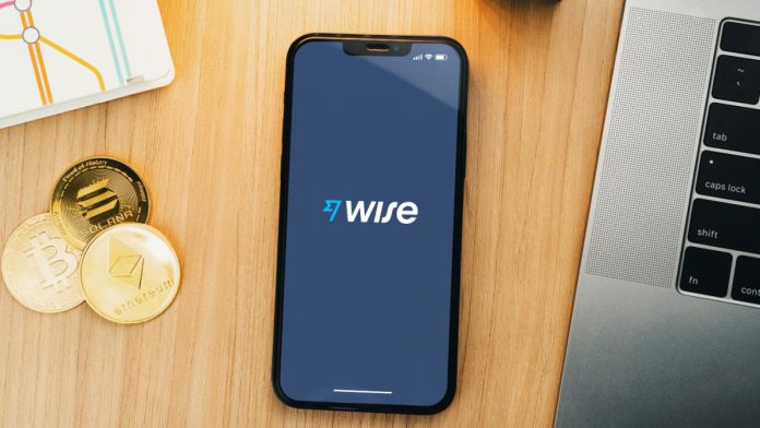 Phone on desk displaying the Wise logo