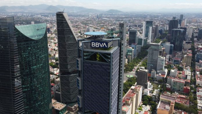 Aerial view of BBVA bank tower and the iconic Paseo de La Reforma avenue during a sunny morning.