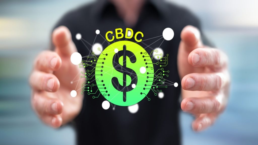 CBDC concept between hands of a man in background.