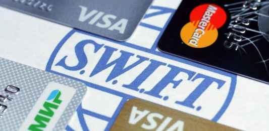 Image of the Swift logo surrounded by payment cards