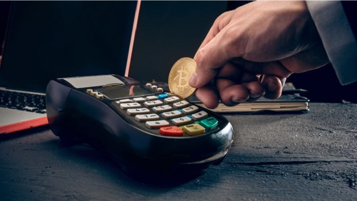 Bitcoin, credit card and POS-terminal. The golden bitcoin in male hands. Cryptocurrency bitcoin coins. Litecoin, Bitcoin, Ethereum, e-commerce, busibess, finance concept. crypto currency symbol.