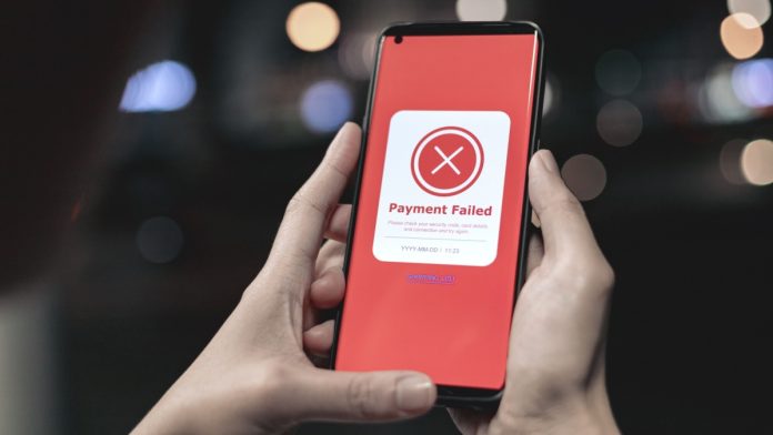 Payment failed, declined. Red online financial transaction notification in application showing error on smartphone. Concept of online banking, encrypting transactions and secure connection.