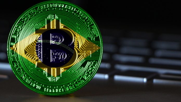 Bitcoin close-up on keyboard background, the flag of Brazil is shown on bitcoin.
