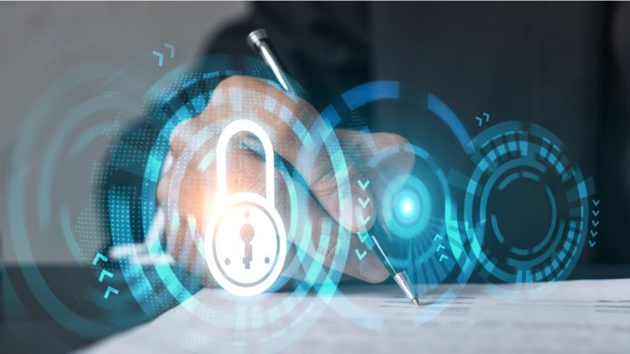Businessman in suit signs contract. Double exposure with lock icon hologram. Man signing agreement on company data security. Safety concept.