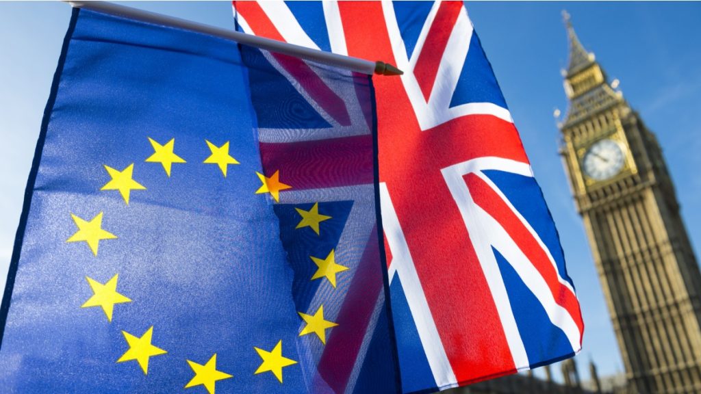 European Union and British Union Jack flag flying in front of Big Ben and the Houses of Parliament at Westminster Palace, London, in symbol of the Brexit EU referendum.