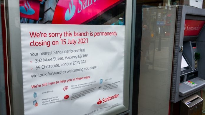 London. UK- 06.25.2021: a permanently closing notice on the window of a high street branch of Santander Bank.