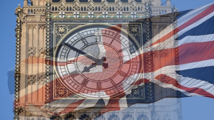 Big Ben, Clock Tower, Parliament House and British Flag merged in a double exposure shot of flag and historic London Building.