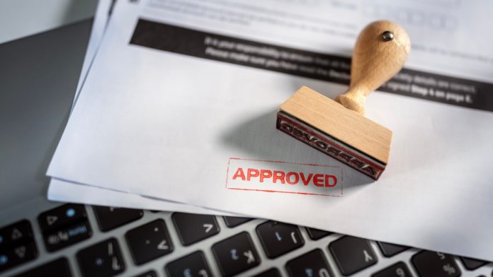 Approved stamp on application form or business agreement document.
