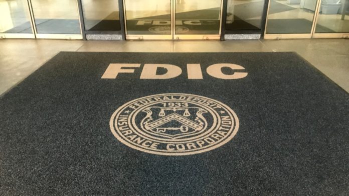 WASHINGTON, DC - JANUARY 4, 2019: FDIC - FEDERAL DEPOSIT INSURANCE CORPORATION headquarters building sign and seal at entrance.