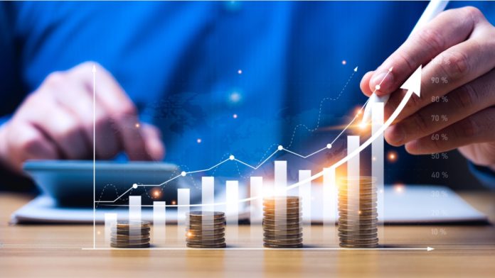 Financial business growth concept. businessperson calculate income and profit on investments and an increase in the indicators of positive growth, with virtual holographic chart graph. rich, coin