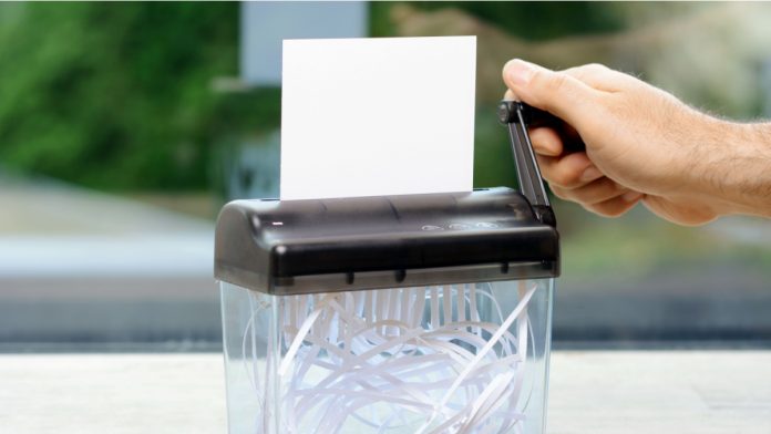 Shredder with empty card with copy space is shredded.