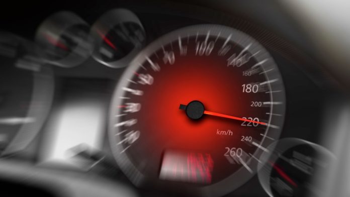 Car speedometer. High speed on a car speedometer and motion blur.
