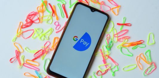 Image of a smartphone with Google Pay logo on it. Illustrating launch of Agentic Pay
