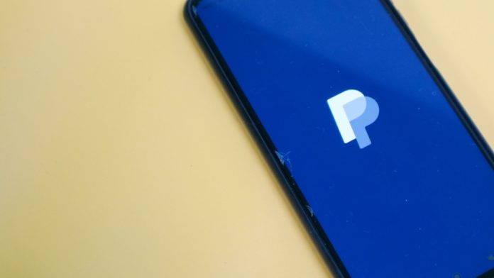 Image of a smart phoen displaying the PaPpal logo following its partnership with Dimoco