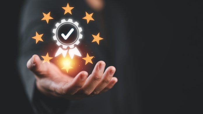 A person holding a business accreditation symbol, representing Jeton making the FT1000 list
