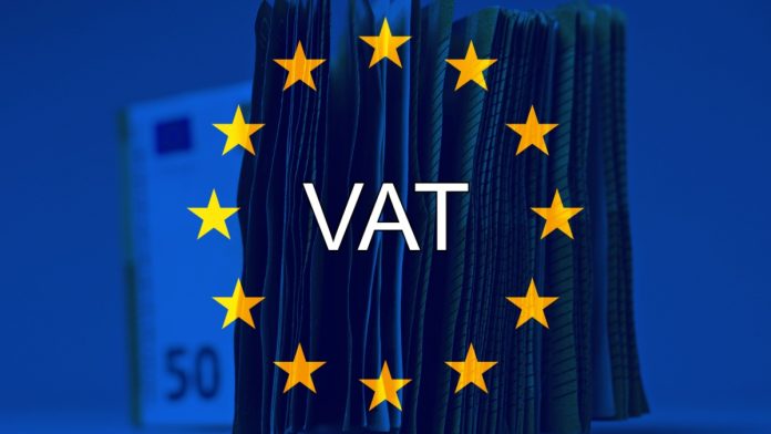Pile of fifty euros on the table , with european flag and the text "Vat". Concept of European taxes.