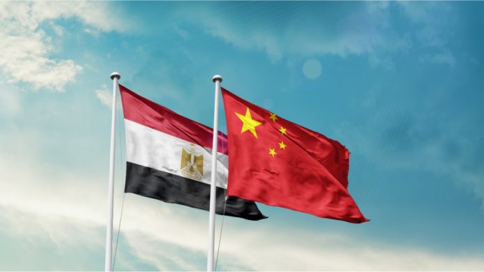 Egypt and China friendship flags are waving in the sky. Double country Flag waving with mast. Egypt china national flag for agreement.