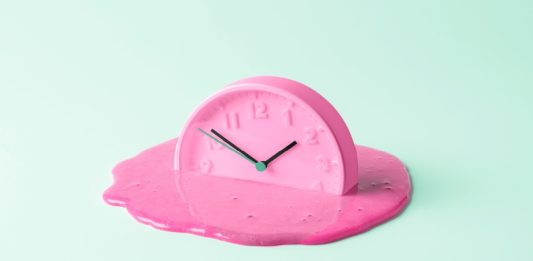 The pink clock melts against the birch background. Creative concept of time, and representative of how long Denmark's payment system failed