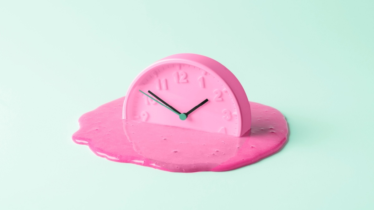 The pink clock melts against the birch background. Creative concept of time, and representative of how long Denmark's payment system failed