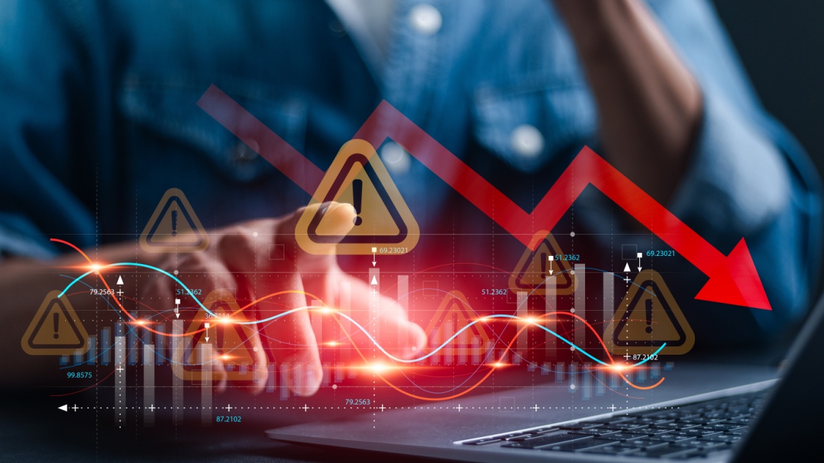 Economic crisis and global economic recession. Businessman use laptop analyze economic graph with warning sign for caution in investing economic situation warning, Business investment risks.