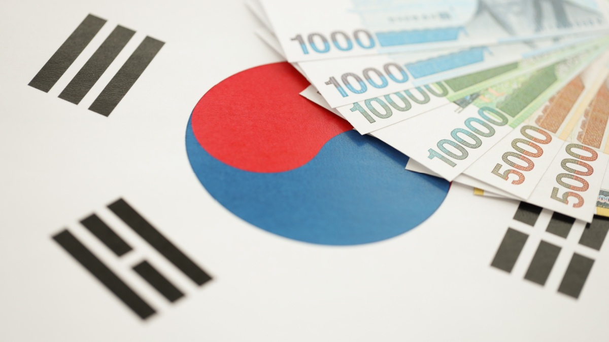 South Korean won money bills in big amount lies on South Korea flag close up