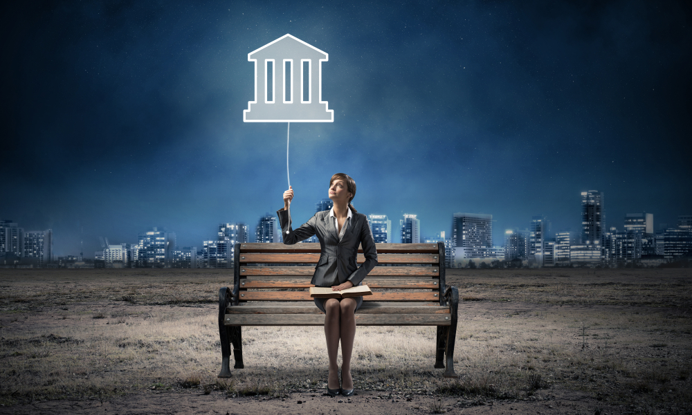 Image of a woman sitting on a bench pulling a light switch leading to a bank representing open banking