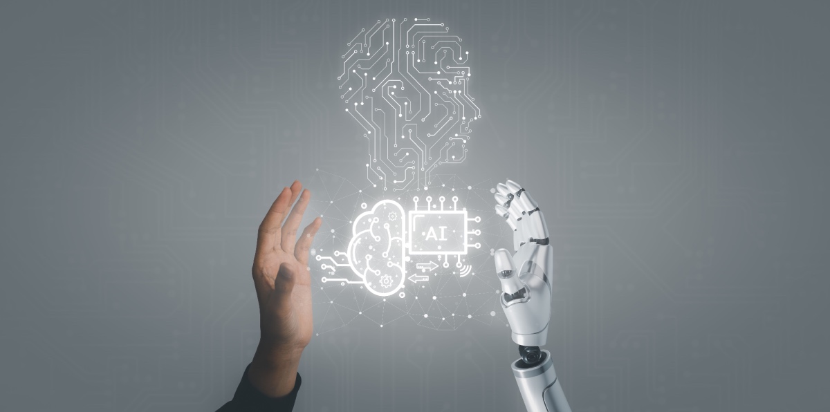 Human hand and robot hand with AI concept in between.