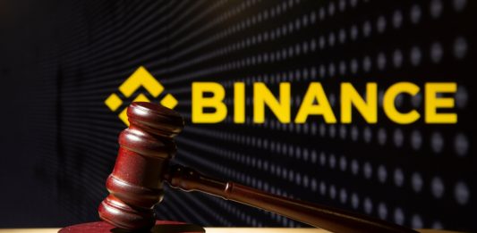 Syktyvkar, Komi, Russia, August 26, 2023, Binance and court session. Judicial hammer on the background of the logo.
