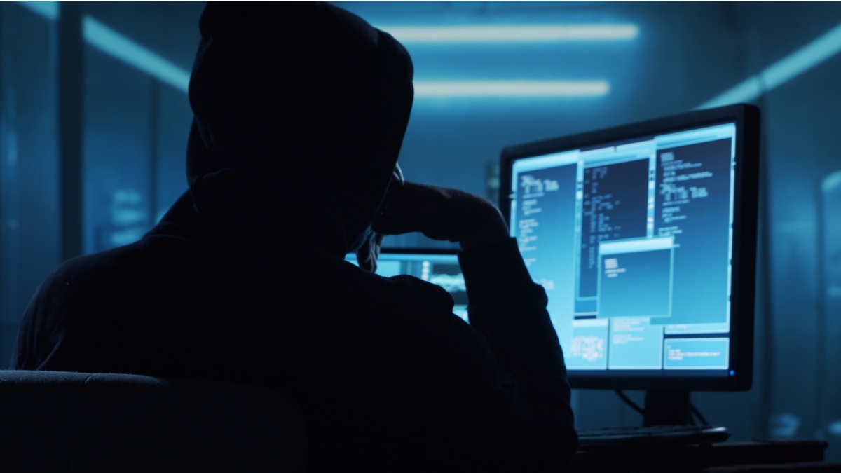 Computer Hacker in Hoodie. Obscured Dark Face. Concept of Hacker Attack, Virus Infected Software, Dark Web and Cyber Security.
