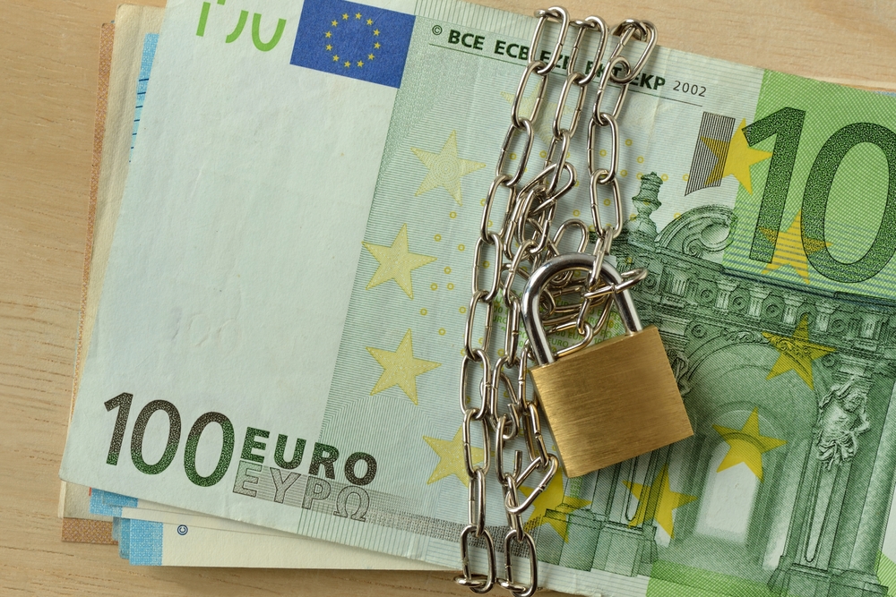 Closeup of euro cash locked with chain and padlock - Stop cash concept