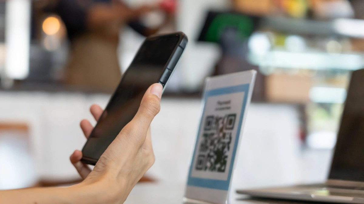 Woman use smartphone to scan QR code in Asia to pay in cafe restaurant with a digital payment without cash. Choose menu and order accumulate discount. E wallet, technology, pay online, credit card, bank app.