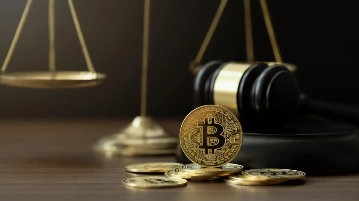 Bitcoin Crypto Regulation And Law. Cryptocurrency laws. Bitcoins and a wooden gavel with a golden scale on the table. Cryptoc regulation and Tax Laws are regulated by the government.