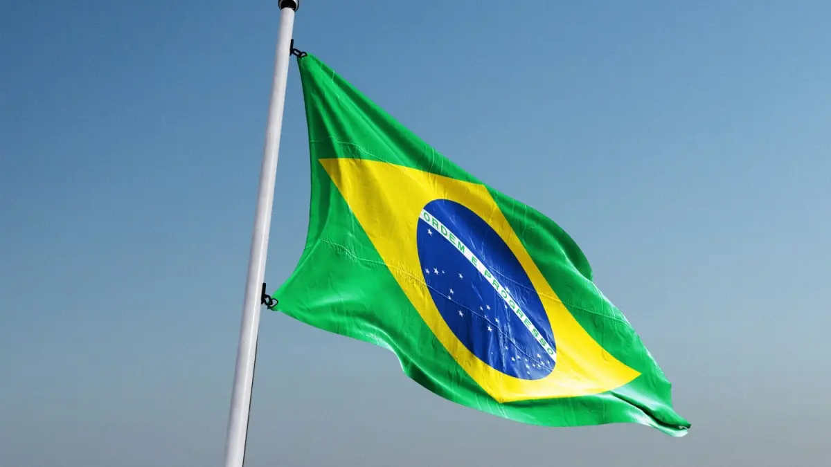 Waving flag of Brazil. Beautiful flag of the Federative Republic of Brazil on a street flagpole.