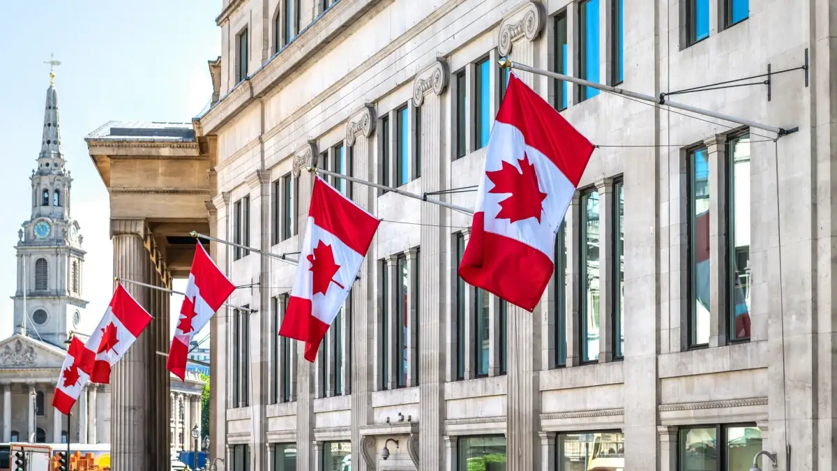 HIgh Commission of Canada or Canadian embassy in London, United Kingdom with row of many flags on Pall Mall East by Trafalgar square