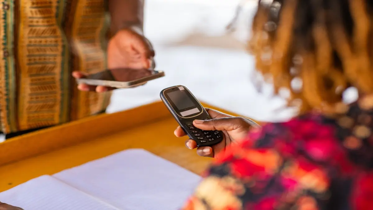 Mobile money (MoMo) in Africa. Digital funds transfer and payments using mobile phones. Fintech, financial inclusion, and cashless transactions.