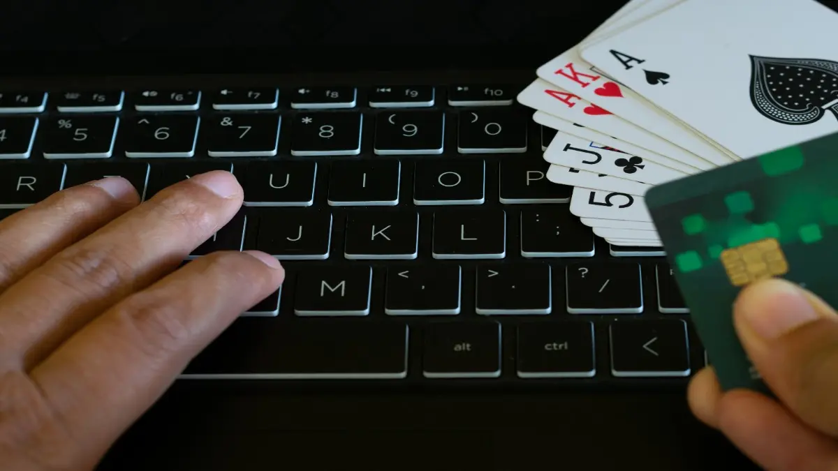 Cards on keyboard hands of person payment for game. Online rummy, poker, casino, black jack, gambling, money, fraud, addiction, advertise, loss, profit, win lose cash club, party